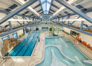 View of pool from above and ceiling mounted HVAC systems designed by 360 Engineering at Larimer County Rec Center in Berthoud.