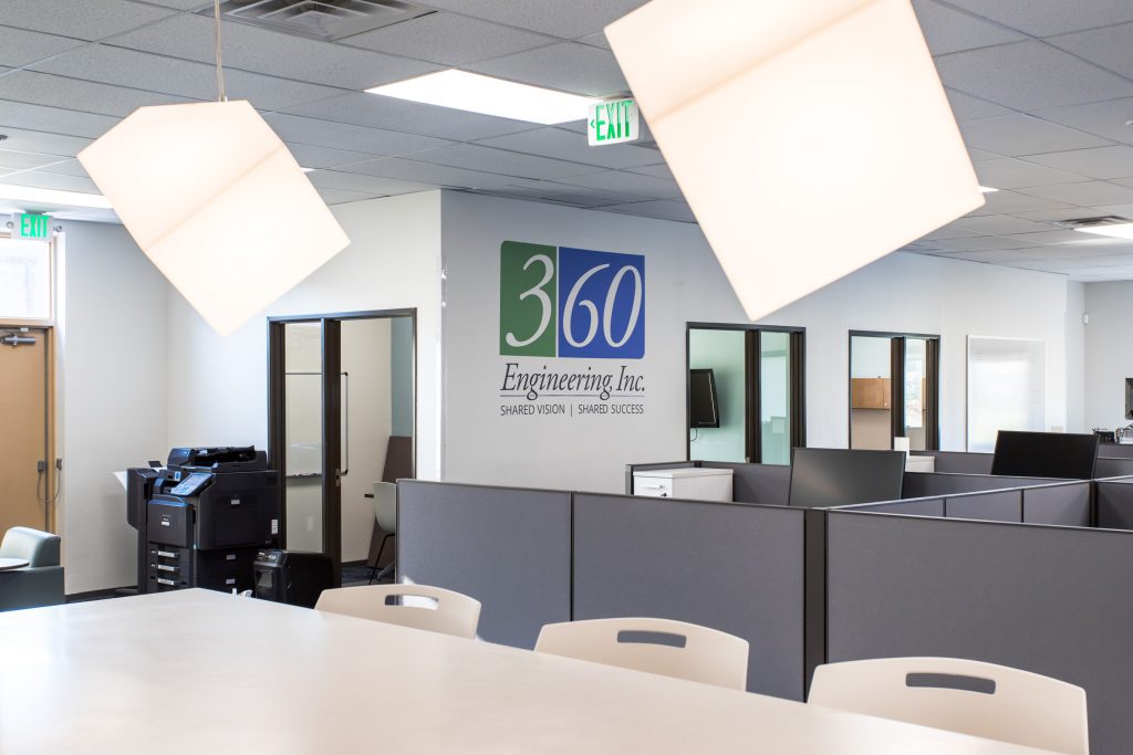 Green and blue 360 Engineering logo on office wall