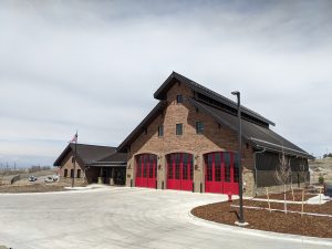 Exterior of brick Fire Station with red garage doors and steal roof in Highlands Ranch, CO.