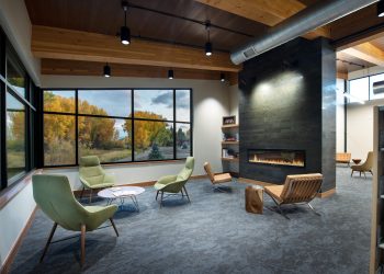 Interior of Gunnison County, Colorado Library fireplace and HVAC above a wide window.