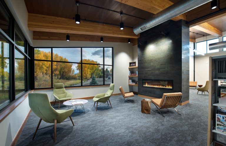 Interior of Gunnison County, Colorado Library fireplace and HVAC above a wide window.